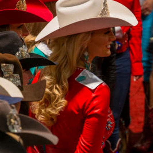 Miss Rodeo Montana 2019, Kayla Seaman, at Miss Rodeo America pageant; wears a red dress with turquoise earrings and a light cowboy hat