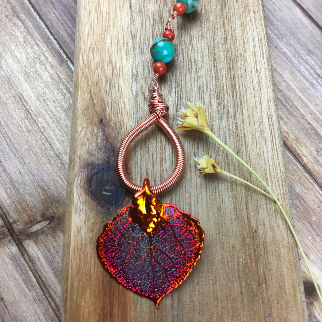 Detail of copper aspen leaf necklace with turquoise and coral